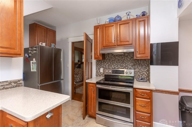 2817 Whittier Ave, Dayton, OH 45420 - kitchen featuring stainless steel appliances, under cabinet range hood, backsplash, and brown cabinets