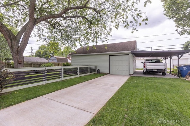 2817 Whittier Ave, Dayton, OH 45420 - view of front of house featuring a garage, driveway, an outdoor structure, and a carport