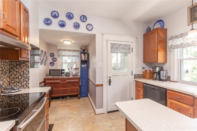 2817 Whittier Ave, Dayton, OH 45420 - kitchen with appliances with stainless steel finishes, light countertops, tasteful backsplash, and brown cabinetry