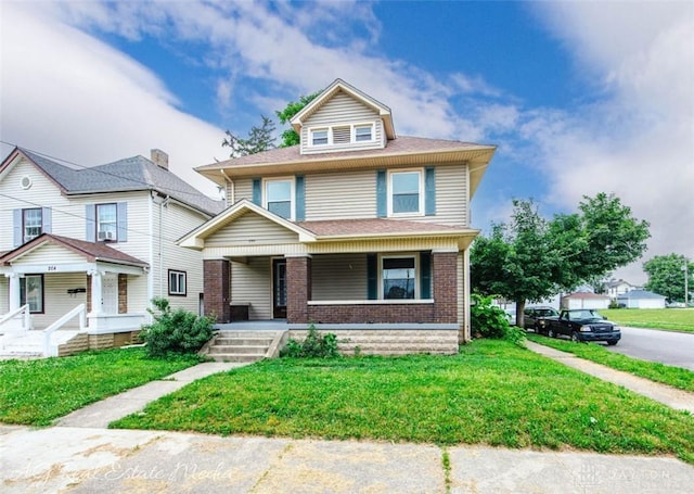200 Garfield St, Middletown, OH 45044 - american foursquare style home with a porch, brick siding, and a front lawn