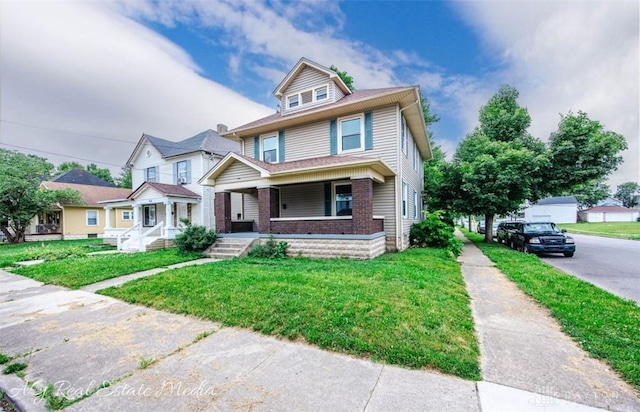 200 Garfield St, Middletown, OH 45044 - traditional style home featuring a porch, a front lawn, and brick siding