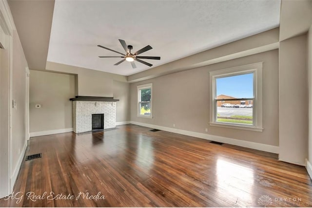 200 Garfield St, Middletown, OH 45044 - unfurnished living room with ceiling fan, wood finished floors, and a brick fireplace