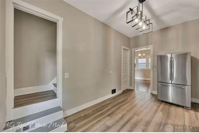 200 Garfield St, Middletown, OH 45044 - unfurnished dining area featuring a chandelier, light wood finished floors, and stairs