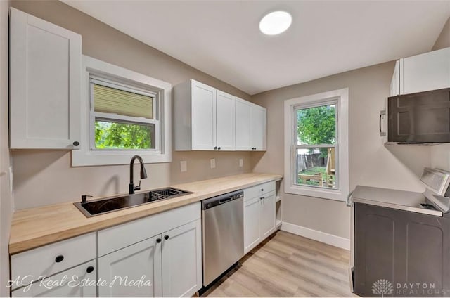 200 Garfield St, Middletown, OH 45044 - kitchen with dishwasher, black microwave, range, light countertops, and white cabinetry
