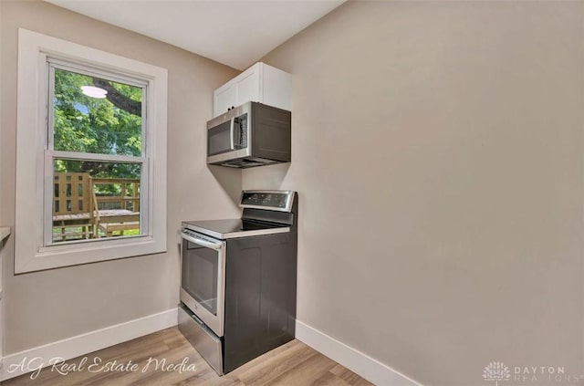 200 Garfield St, Middletown, OH 45044 - kitchen featuring appliances with stainless steel finishes, light wood finished floors, and white cabinets
