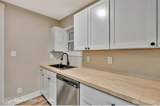 200 Garfield St, Middletown, OH 45044 - kitchen with stainless steel dishwasher, white cabinetry, and butcher block counters