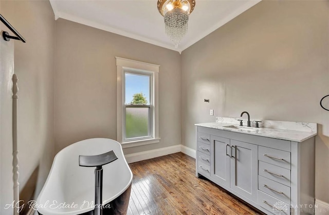 200 Garfield St, Middletown, OH 45044 - full bathroom with a freestanding bath, vanity, wood-type flooring, and crown molding