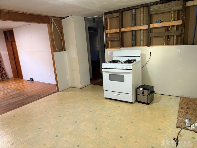 4904 Alpha Rd, Springfield, OH 45504 - kitchen featuring white range with gas stovetop and light floors