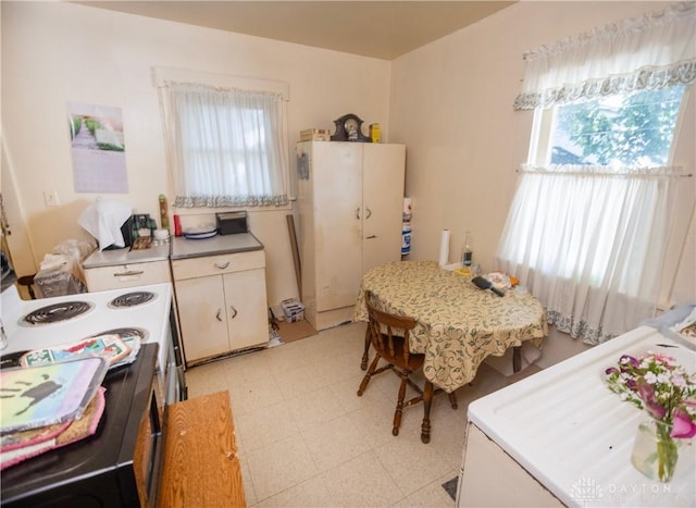 2107 Woodlawn Ave, Middletown, OH 45044 - kitchen featuring light floors, light countertops, white cabinets, and white appliances