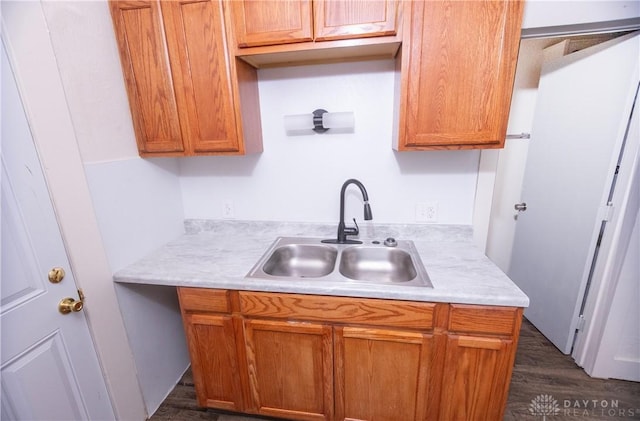 2107 Woodlawn Ave, Middletown, OH 45044 - kitchen featuring light countertops, dark wood finished floors, and brown cabinetry