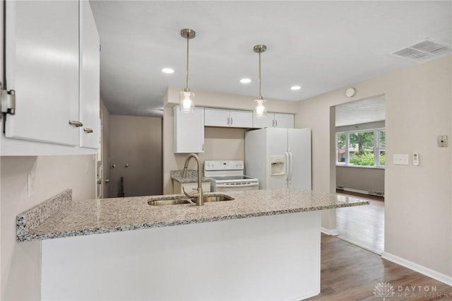 40 Rosewood Dr, Springboro, OH 45066 - kitchen featuring white appliances, a peninsula, white cabinetry, light stone countertops, and recessed lighting