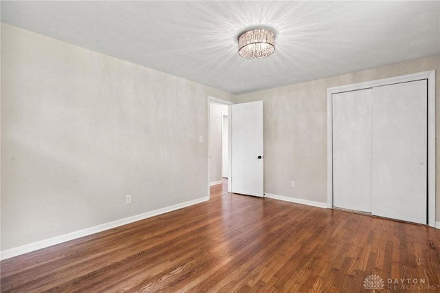 40 Rosewood Dr, Springboro, OH 45066 - unfurnished bedroom featuring wood finished floors, a closet, and a chandelier