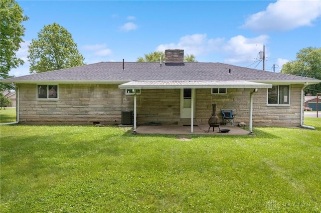 40 Rosewood Dr, Springboro, OH 45066 - rear view of house with stone siding, a chimney, a patio area, a yard, and a shingled roof