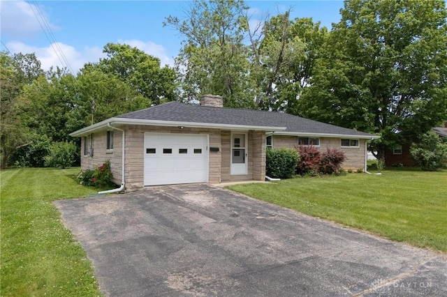 40 Rosewood Dr, Springboro, OH 45066 - single story home with a garage, a chimney, asphalt driveway, a front lawn, and stone siding