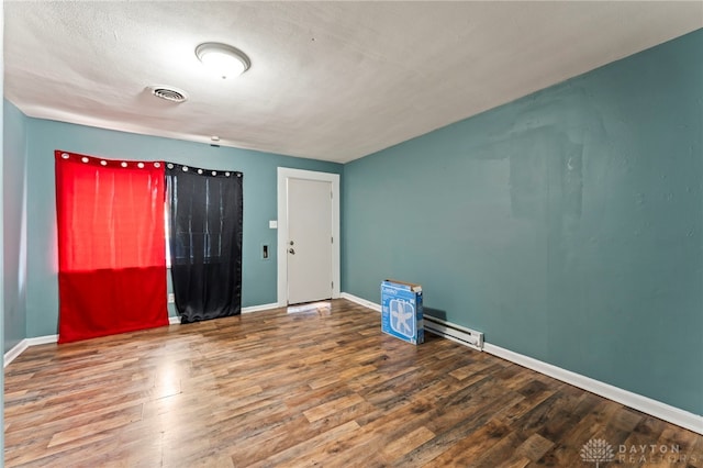 3558 Stanford Pl, Dayton, OH 45406 - spare room featuring wood finished floors and a baseboard heating unit