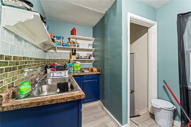 3558 Stanford Pl, Dayton, OH 45406 - kitchen with blue cabinetry, open shelves, a textured ceiling, light wood-style flooring, and dark countertops