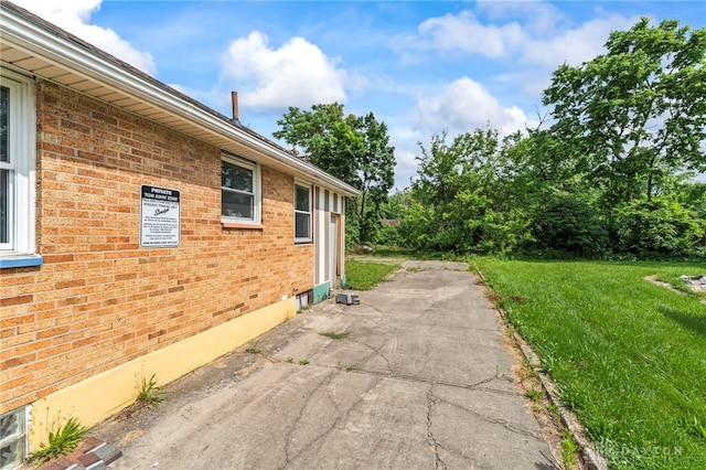 3558 Stanford Pl, Dayton, OH 45406 - view of home's exterior with a patio area, brick siding, and a yard