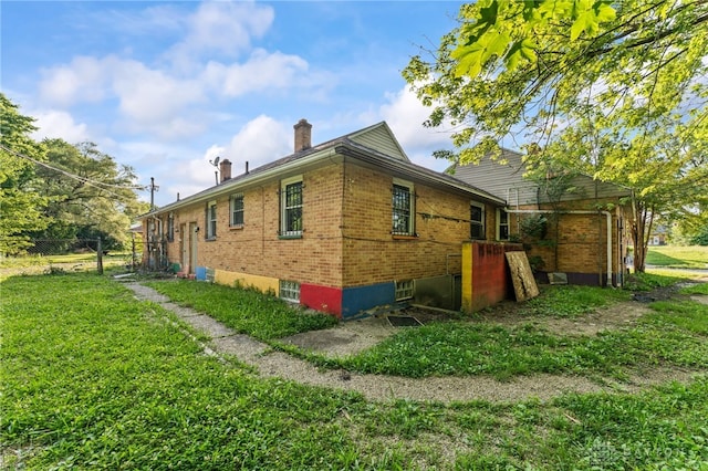 3558 Stanford Pl, Dayton, OH 45406 - view of side of property featuring brick siding, a chimney, and a lawn