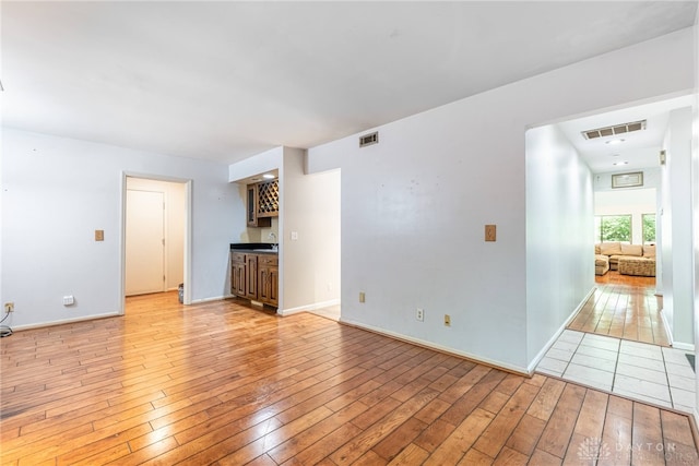 1839 Quail Hollow Rd, Washington Twp, OH 45459 - unfurnished living room with light wood-type flooring and bar with sink