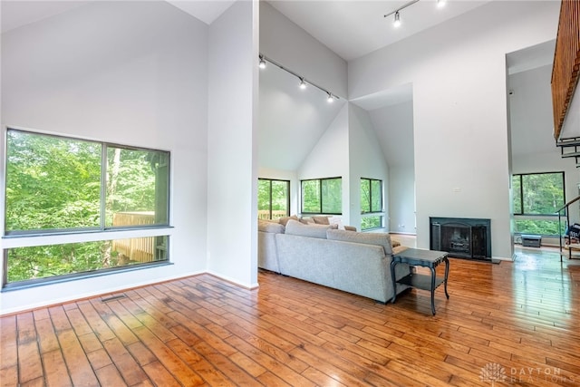 1839 Quail Hollow Rd, Washington Twp, OH 45459 - living area with track lighting, high vaulted ceiling, a fireplace with raised hearth, and hardwood / wood-style floors