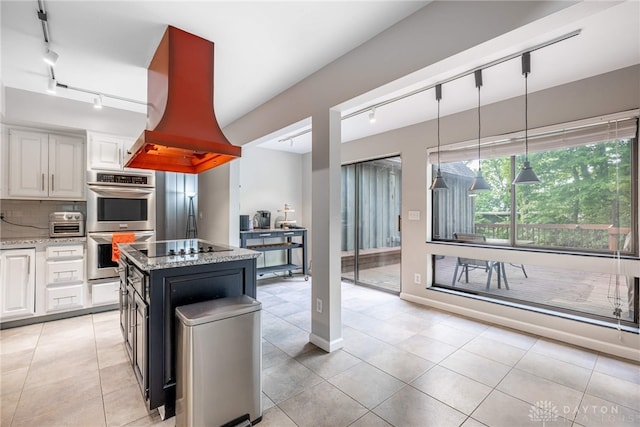 1839 Quail Hollow Rd, Washington Twp, OH 45459 - kitchen with rail lighting, custom range hood, stainless steel double oven, light stone countertops, and white cabinets