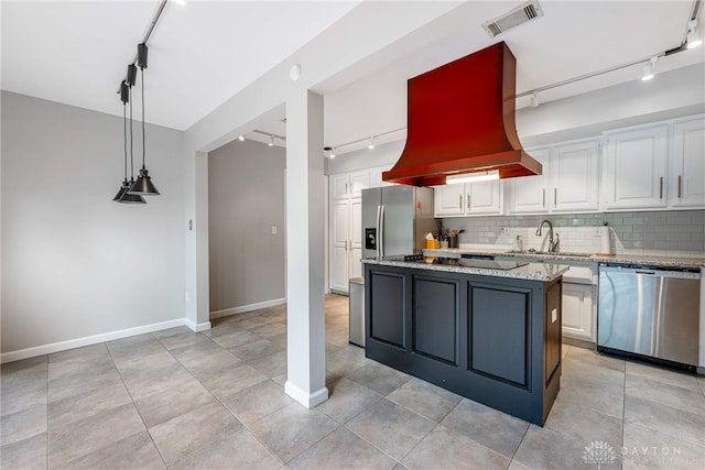 1839 Quail Hollow Rd, Washington Twp, OH 45459 - kitchen featuring track lighting, appliances with stainless steel finishes, premium range hood, and white cabinets
