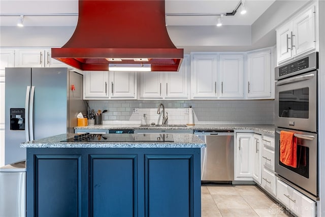 1839 Quail Hollow Rd, Washington Twp, OH 45459 - kitchen featuring rail lighting, stainless steel appliances, premium range hood, a center island, and tasteful backsplash