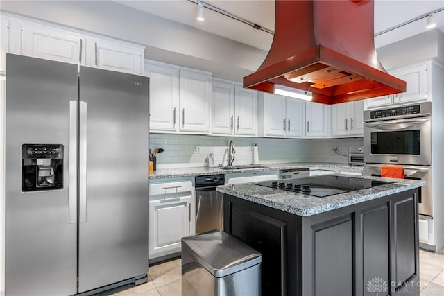 1839 Quail Hollow Rd, Washington Twp, OH 45459 - kitchen with appliances with stainless steel finishes, island range hood, track lighting, white cabinets, and light tile patterned floors