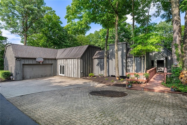1839 Quail Hollow Rd, Washington Twp, OH 45459 - view of front of home featuring an outbuilding, decorative driveway, a garage, and roof with shingles