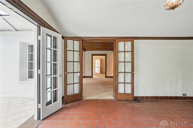 1160 Lytle Ln, Kettering, OH 45409 - spare room with french doors, tile patterned floors, vaulted ceiling, and a textured wall