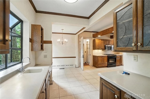 1160 Lytle Ln, Kettering, OH 45409 - kitchen featuring gas stove, stainless steel microwave, crown molding, light countertops, and a baseboard radiator