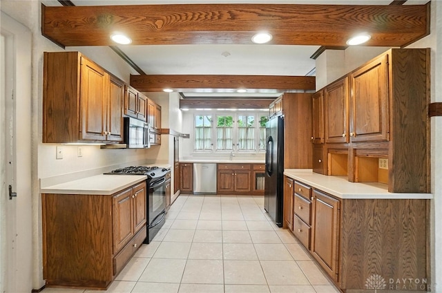 1160 Lytle Ln, Kettering, OH 45409 - kitchen with black appliances, light tile patterned flooring, brown cabinets, light countertops, and recessed lighting
