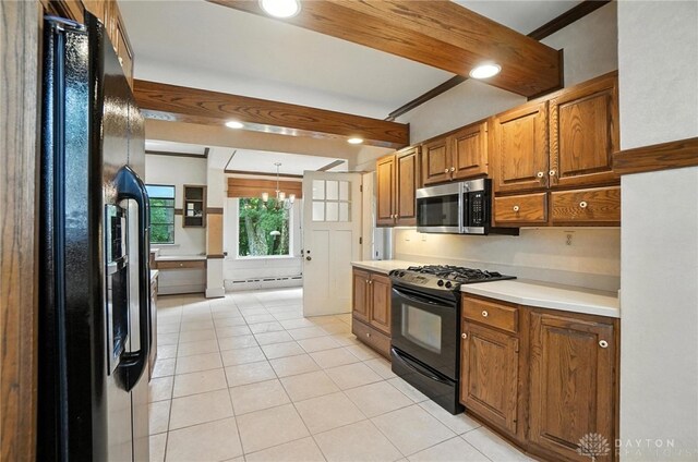1160 Lytle Ln, Kettering, OH 45409 - kitchen with black appliances, baseboard heating, light tile patterned floors, light countertops, and brown cabinetry