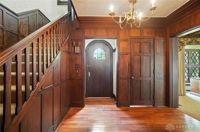 1160 Lytle Ln, Kettering, OH 45409 - entryway with light wood-style floors, a chandelier, plenty of natural light, crown molding, and stairs