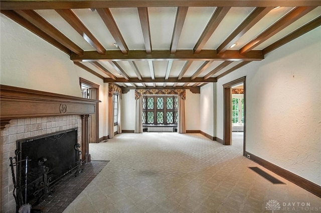 1160 Lytle Ln, Kettering, OH 45409 - unfurnished living room with beamed ceiling, a tiled fireplace, and light carpet