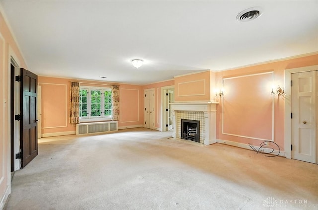 1160 Lytle Ln, Kettering, OH 45409 - unfurnished living room featuring radiator, a fireplace, and light colored carpet