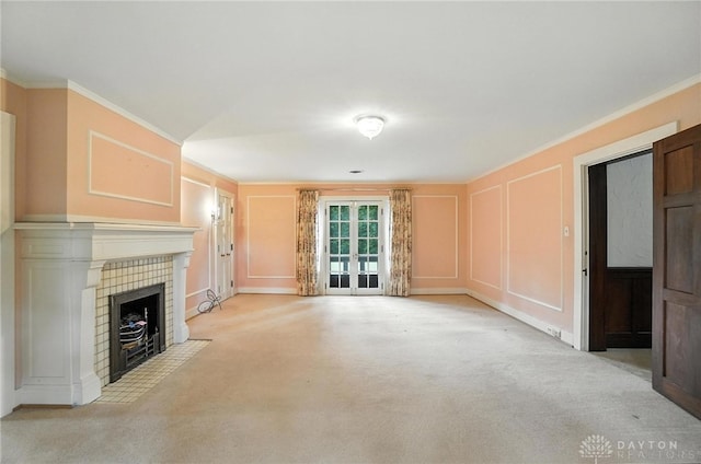 1160 Lytle Ln, Kettering, OH 45409 - unfurnished living room featuring a decorative wall, ornamental molding, french doors, carpet floors, and a fireplace