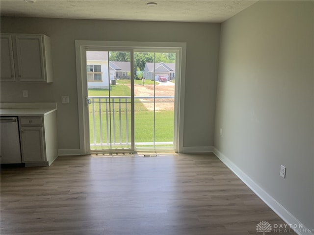 6655 Roycroft Dr, Middletown, OH 45042 - unfurnished dining area featuring light wood-type flooring and a textured ceiling