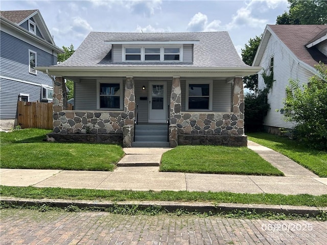 1410 Carlisle Ave, Dayton, OH 45420 - bungalow featuring stone siding, a porch, and a shingled roof