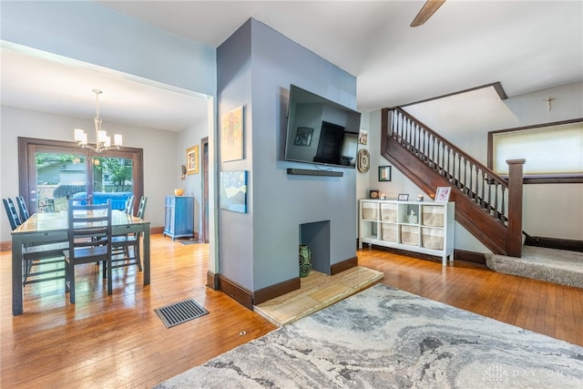 1525 Crescent Blvd, Kettering, OH 45409 - living room featuring a chandelier, stairs, and hardwood / wood-style flooring