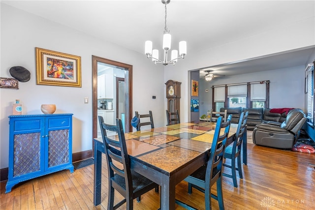 1525 Crescent Blvd, Kettering, OH 45409 - dining room featuring a chandelier, light wood-style flooring, and a ceiling fan