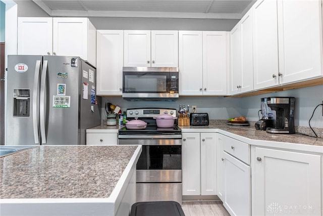 1525 Crescent Blvd, Kettering, OH 45409 - kitchen with stainless steel appliances, white cabinetry, and light wood-style floors