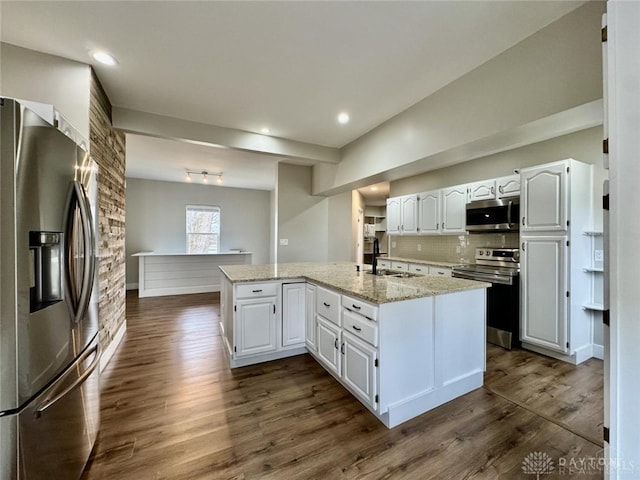 356 Old St Unit 122, Clearcreek Twp, OH 45036 - kitchen featuring appliances with stainless steel finishes, white cabinetry, dark wood-type flooring, light stone counters, and recessed lighting