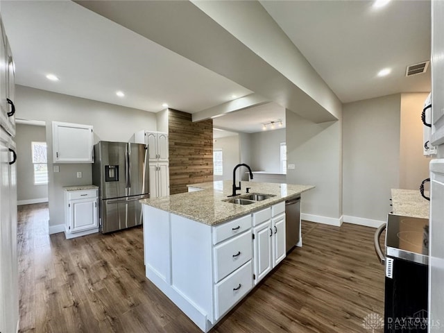 356 Old St Unit 122, Clearcreek Twp, OH 45036 - kitchen featuring stainless steel appliances, white cabinets, dark wood-style floors, a center island with sink, and light stone counters