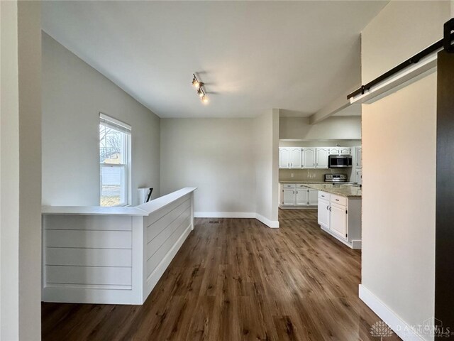 356 Old St Unit 122, Clearcreek Twp, OH 45036 - hall with dark wood-style floors and a barn door