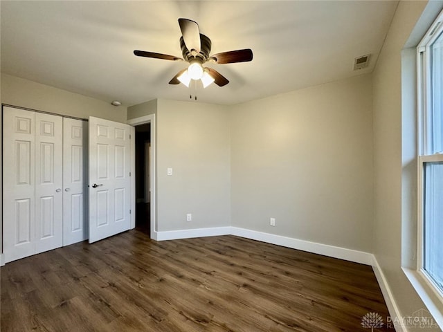 356 Old St Unit 122, Clearcreek Twp, OH 45036 - unfurnished bedroom with dark wood finished floors, ceiling fan, and a closet