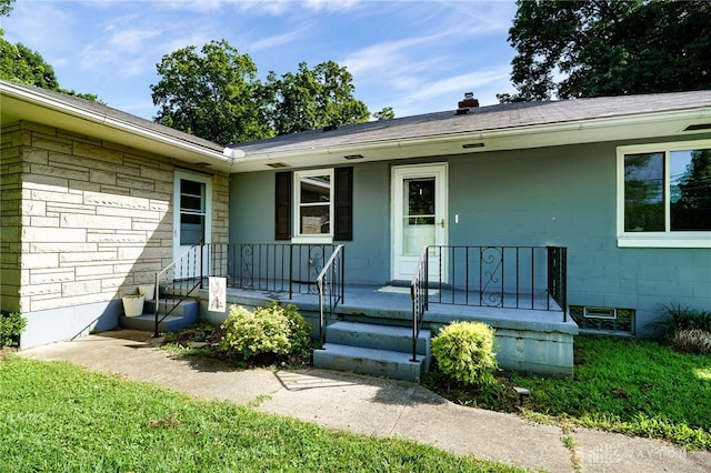 732 Central Ave, Franklin, OH 45005 - view of exterior entry featuring stone siding, a porch, and concrete block siding