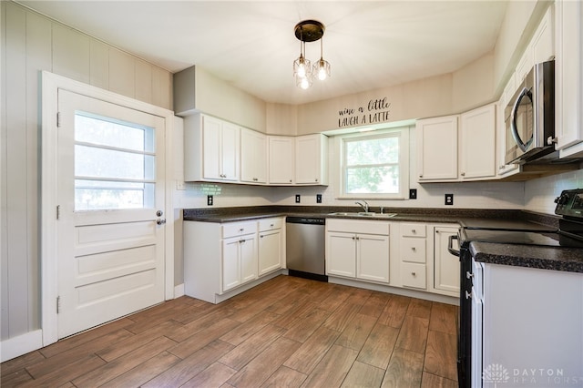 732 Central Ave, Franklin, OH 45005 - kitchen featuring appliances with stainless steel finishes, dark wood-style floors, white cabinetry, and dark countertops