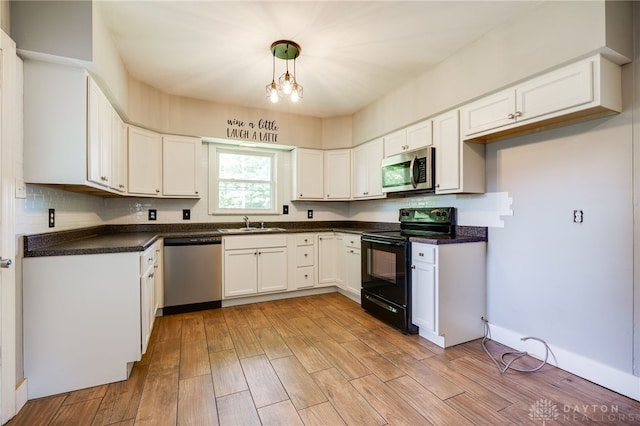 732 Central Ave, Franklin, OH 45005 - kitchen featuring stainless steel appliances, dark countertops, backsplash, and white cabinetry