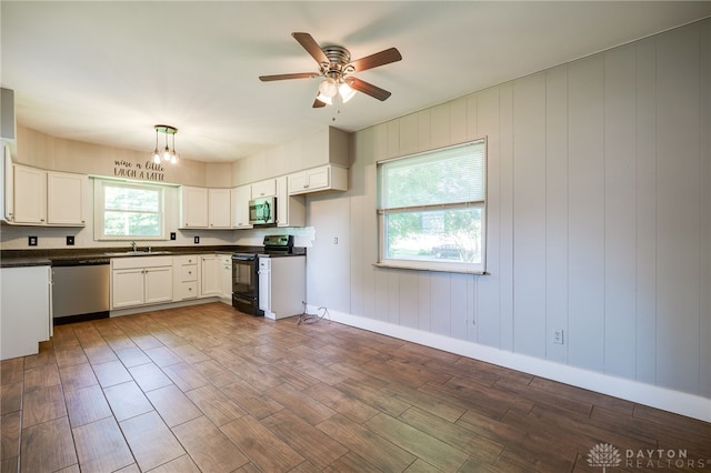 732 Central Ave, Franklin, OH 45005 - kitchen featuring appliances with stainless steel finishes, dark countertops, dark wood finished floors, and ceiling fan